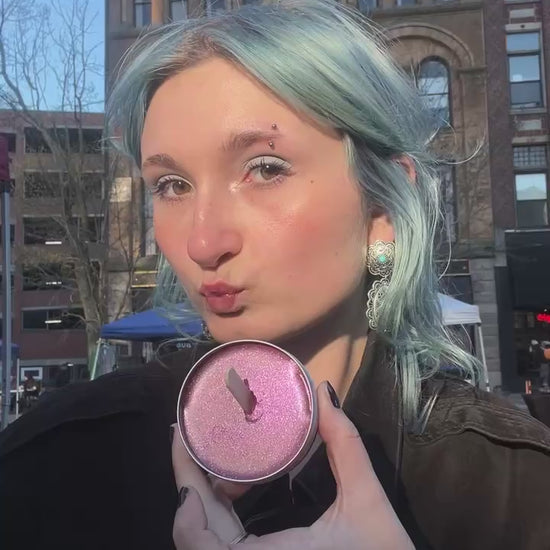 Beautiful young lady applying rose gold Salty Girl Tint shimmer to cheeks.