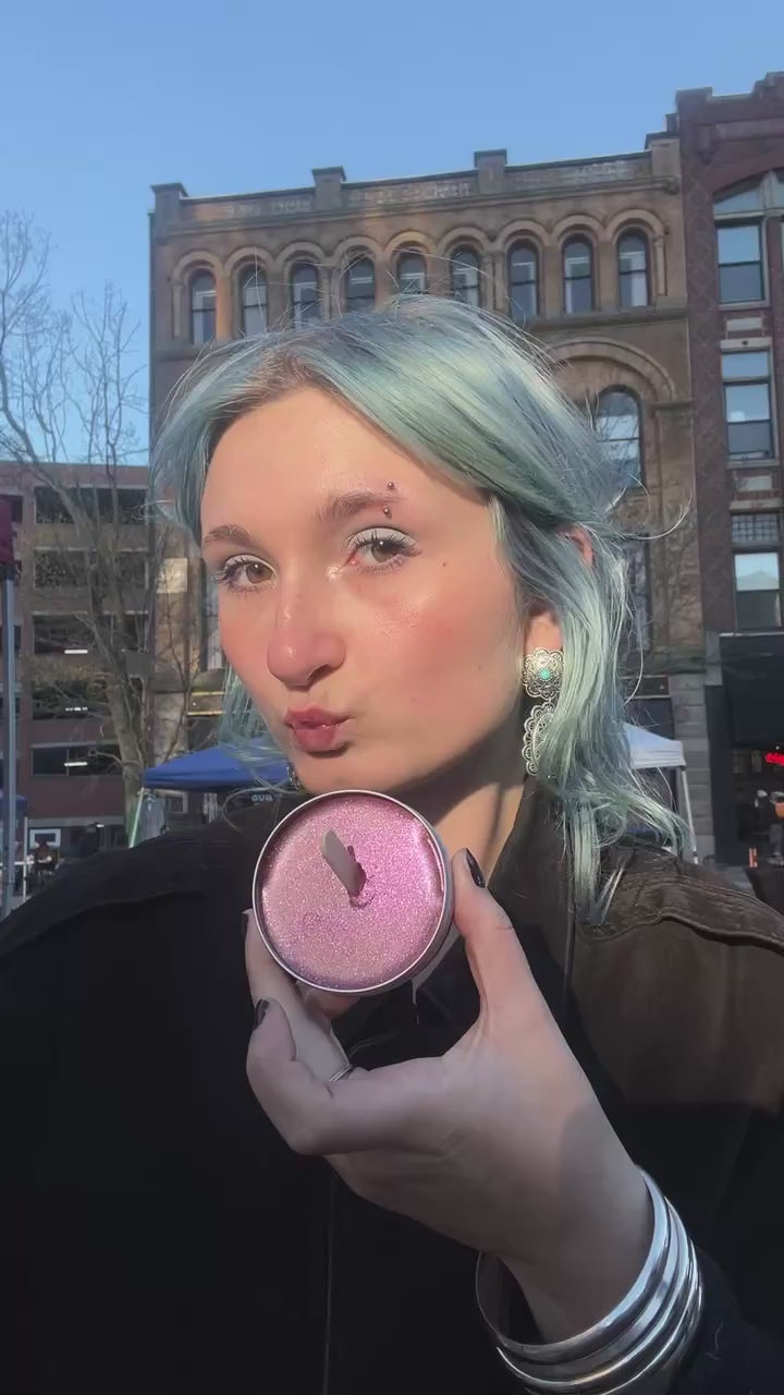 Beautiful young lady applying rose gold Salty Girl Tint shimmer to cheeks.